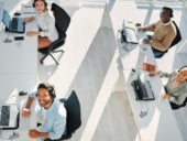 Smiling group of four call centre workers