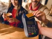 cropped view of man holding credit card while paying in cafe