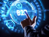 Businessman interacting with a virtual B2B button on a virtual screen.