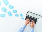 Business man sending and receiving email using laptop on white table.