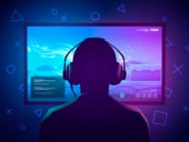 Vector illustration of a young gamer sitting in front of a screen and playing a video game while wearing headphones.