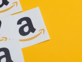 Amazon logo printed onto paper on yellow background.